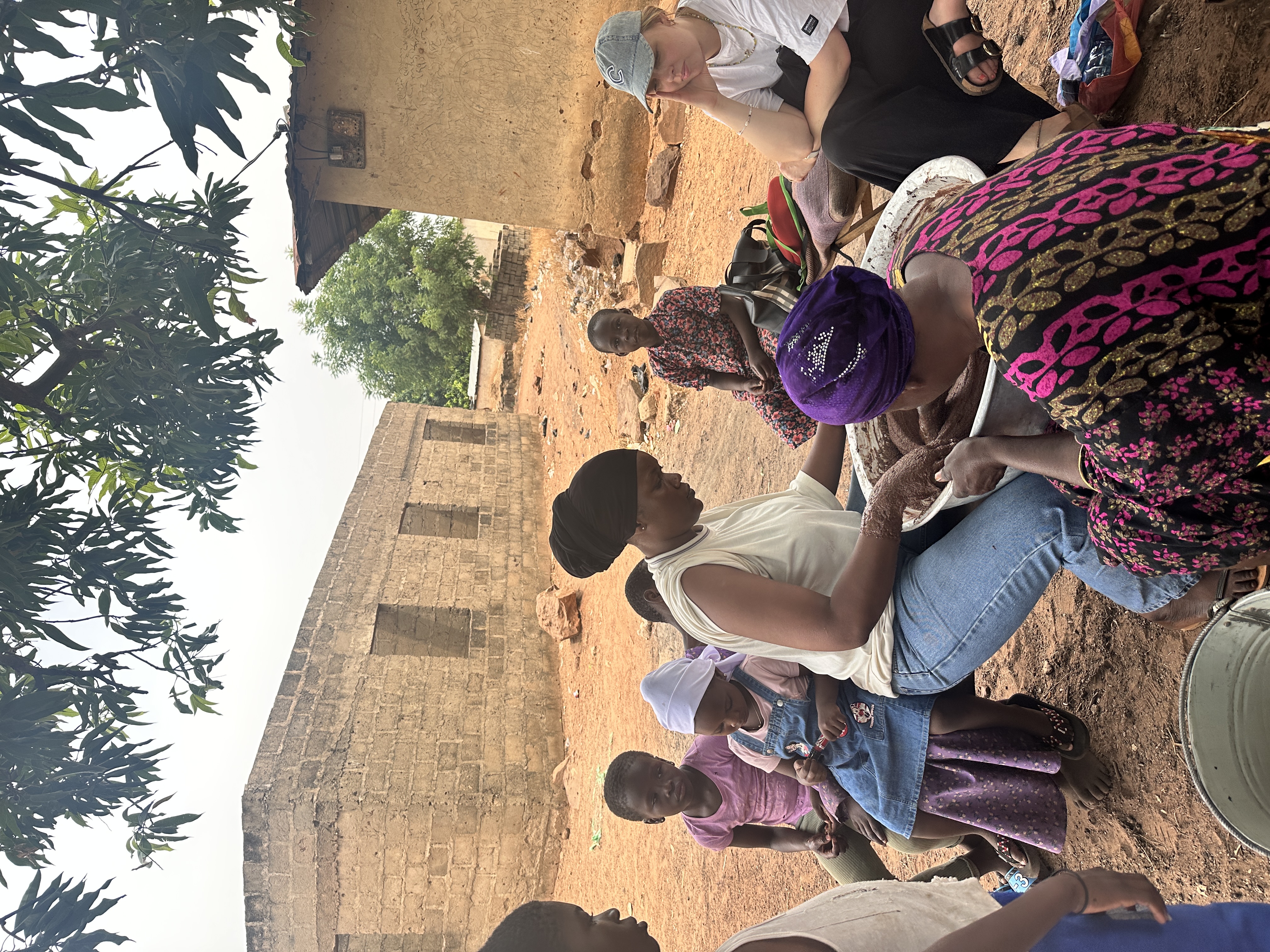 Community shea butter making session with several women working together, Tamale, Northern Ghana